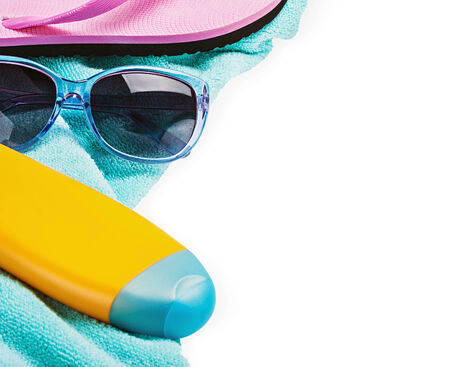 beach gear on a towel isolated on white background. Focus on glasses Sun Protection and middle frame