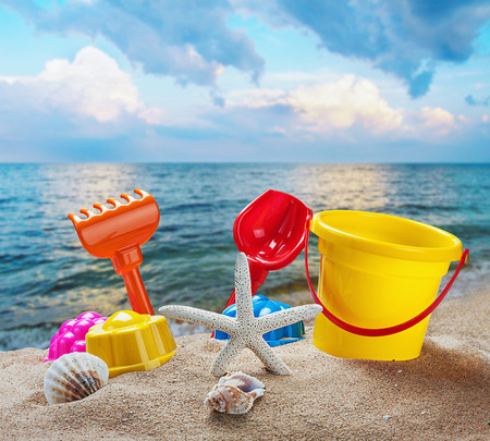 toys for childrens sandboxes against the sea and the beachの写真素材