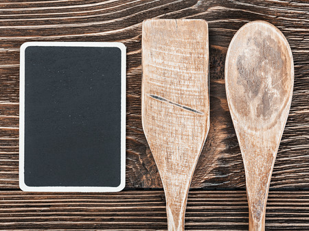 Wooden kitchen utensils and a blackboardの写真素材