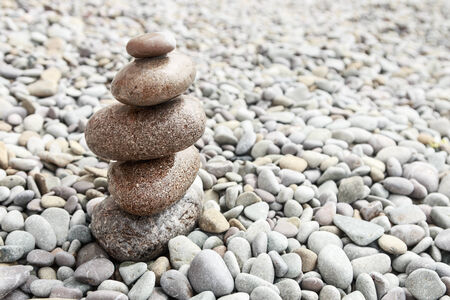 pyramid of stones on sea beach backgroundの写真素材