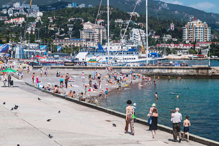 YALTA - June 10, 2014: People relax and swim at the beach in Yalta. Yalta resort town in the southern Crimea.のeditorial素材