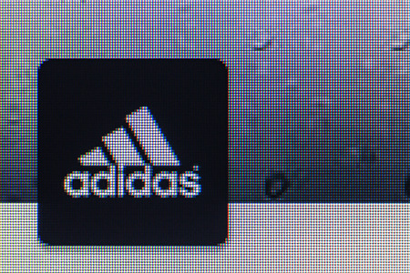 Moscow, Russia - September 24, 2014: adidas logo on the screen of a computer monitor. Adidas German industrial group specializing in the production of athletic footwear, apparel and equipment.のeditorial素材