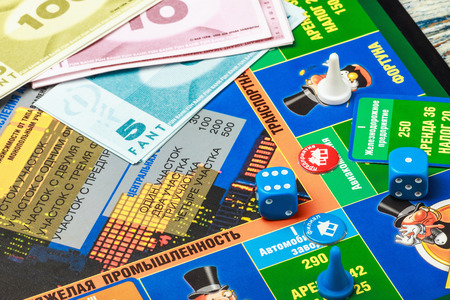 Moscow, Russia - September 11, 2014: Monopoly game on the table. Monopoly game in Russian, a board game in the genre of economic strategy for two or more people.のeditorial素材