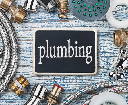 plumbing and aktsessoryes on wooden table backgroundの写真素材