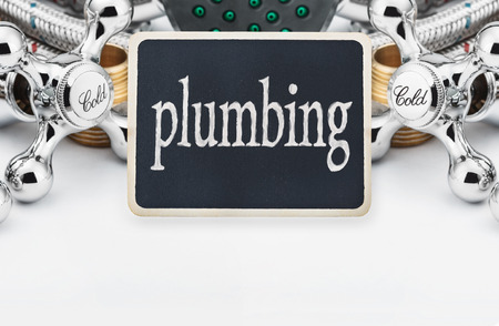 plumbing and a blackboard with the text on a light backgroundの写真素材