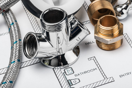 plumbing and tools lying on drawing for repairの写真素材