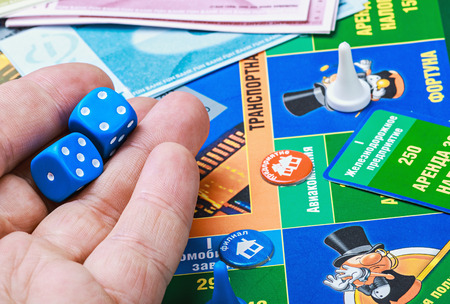 Moscow, Russia - September 11, 2014: Monopoly game on the table. Monopoly game in Russian, a board game in the genre of economic strategy for two or more people.のeditorial素材