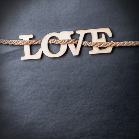 carved wooden letters love on a black background. Place on a black background can be used for congratulationsの写真素材