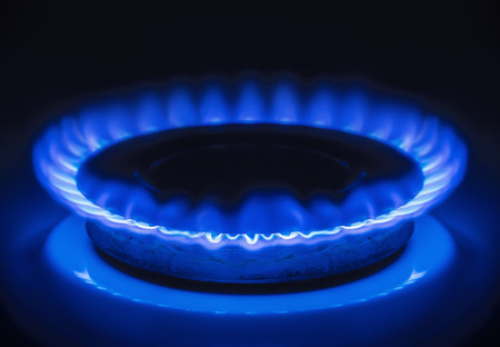 Burning blue gas. Focus on the front edge of the gas burners.