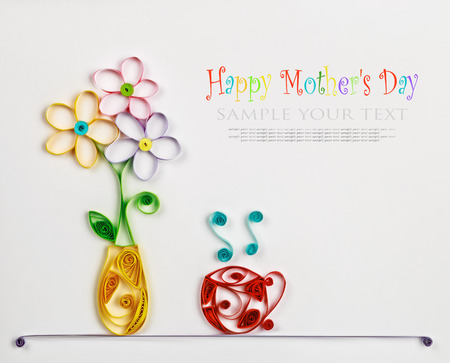 colorful flowers in a vase and a hot cup made of quilling. の写真素材