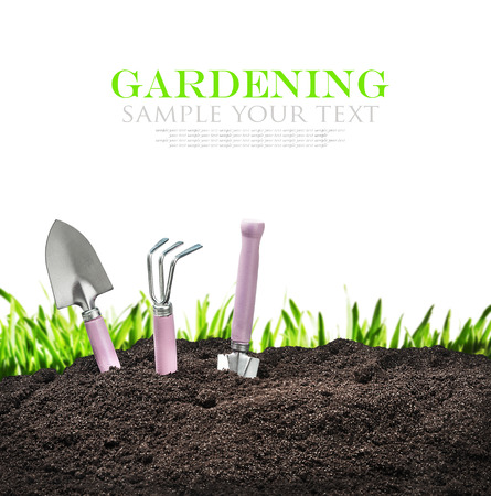 garden tools in soil isolated on white background. The text is an example and can be easily removedの写真素材