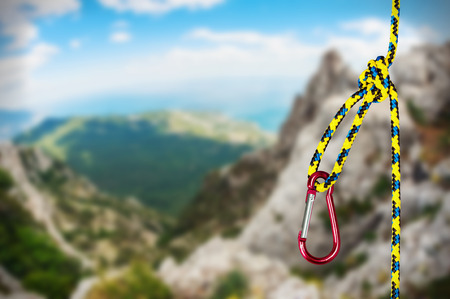 rock climbing rope with hooks on a background of mountains. focus on the ropeの写真素材