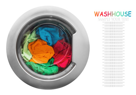 colorful clothes in the washing machine on a white background. focus on laundry. Text exampleの写真素材