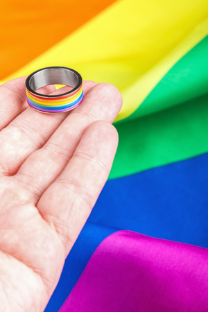 Ring rainbow gay in the palm of community on the flag. Focus on the ringの写真素材