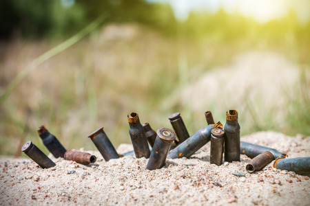 rusty bullet shells on the battlefield. Focus on the bulletの写真素材
