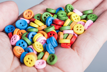 Multi colored buttons in handの写真素材
