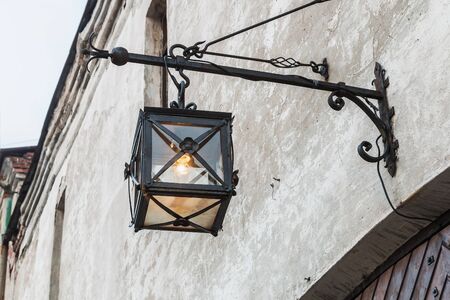 Ancient lantern on the wall in old city streetsの写真素材