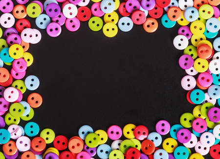 Multicolored buttons on a black background. shallow depth of field.