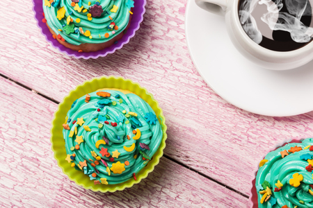 Fresh cupcakes and coffee on the wooden tableの写真素材