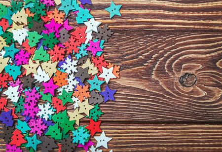 carved wooden buttons on the theme of Christmas at the table. focus on the tableの写真素材