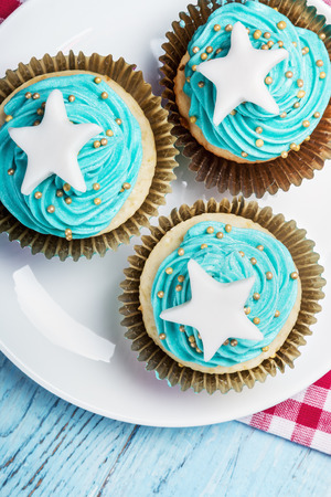 Christmas cupcakes with a star on the wooden table. focus on cupcakesの写真素材