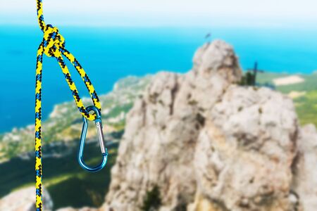 rock climbing rope with hooks on a background of mountains. focus on the ropeの写真素材