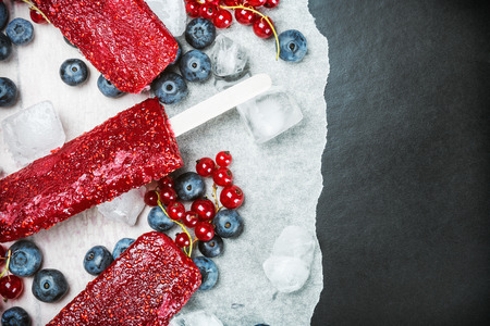 Homemade  ice pop with red currant and mint on black backgroundの写真素材