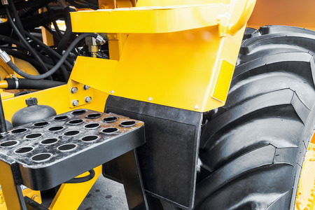 yellow bulldozer with a big wheel. focus on the wheelの写真素材