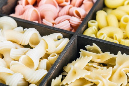 pasta assortment of different colors in a wooden boxの写真素材