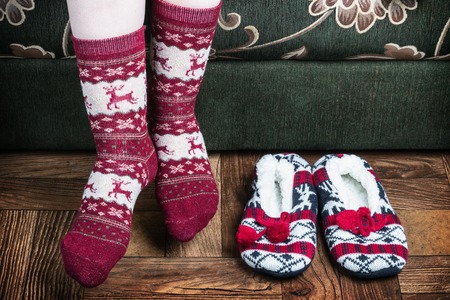 Christmas female legs in socks and slippers. vignette for artistic effectの写真素材