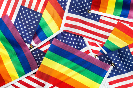flags of the LGBT community on a background of the American flagの写真素材