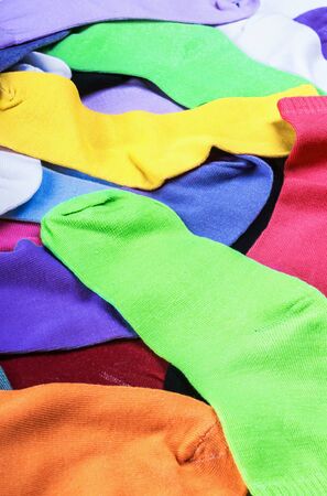 Textile colorful socks background. Green, pink, red, orange, yellow and other colorsの写真素材