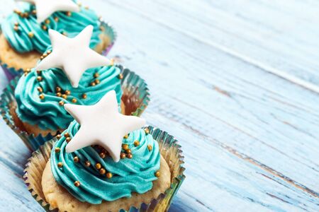 Christmas cupcakes with a star on the wooden tableの写真素材
