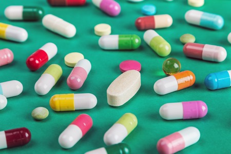 pills and tablets of different colors backgroundの写真素材