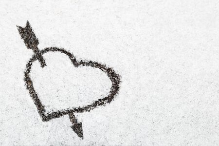 heart drawn in the snow background. Decoration on the day of valentine or love