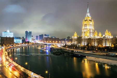 view of the hotel Ukraine Radisson Royal Hotel , Government Building, and Moskva River in Moscow evening. Focus on hotel Ukraineの写真素材