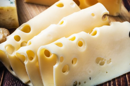 Fresh cut maasdam cheese. Vignette as artistic effectの写真素材