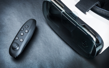 Virtual reality glasses and remote control for games on a black backgroundの写真素材