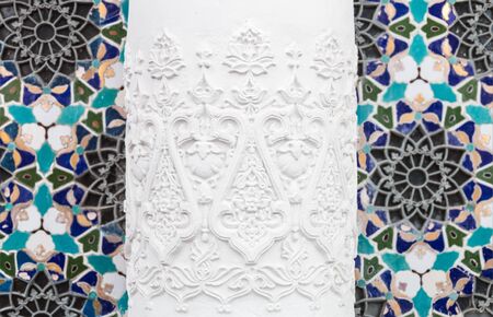 Bas-reliefs with patterns and ornaments on a wall background with mosaicの写真素材