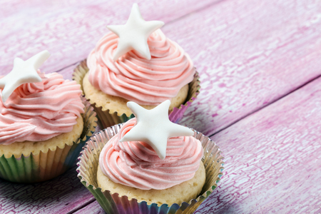 Christmas cupcakes with a star on the wooden tableの写真素材