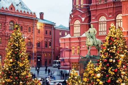MOSCOW, RUSSIA - DECEMBER 22 , 2017: townspeople and tourists walk by Manezhnaya square decorated...