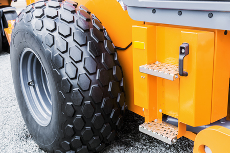 big tyre of a tractor or bulldozer. The details of the construction or repair of equipmentの写真素材
