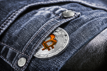 coin cryptocurrency bitcoin in your jeans pocket. bitcoin the most Popular cryptocurrency in the world. Toned imageの写真素材