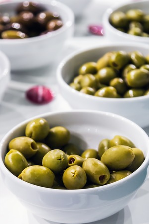 olives canned meats of different varieties on the table. Shallow depth of field.の写真素材