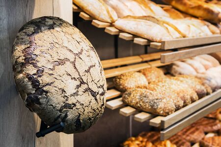freshly baked bread and bakery products on the counter. focus on a loaf of bread
