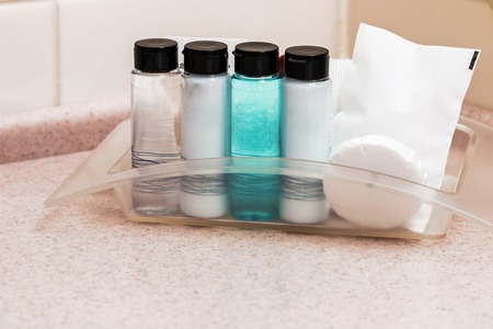 tool for taking a shower and toiletries on the countertop in a hotel bathroomの写真素材