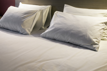 pillows on the large double bed. The concept of preparing a bed in a hotel room or at home. Modern interiorの写真素材