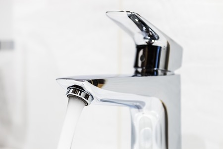 water faucet in the bathroom or toilet. water flows from the tapの写真素材