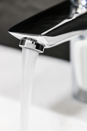 water faucet in the bathroom or toilet. water flows from the tap