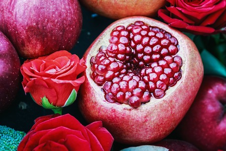 ripe fruit pomegranate, apple and beautiful roses in still life. Decorations for home and gardenの写真素材